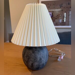 Gray ceramic table lamp with cream pleated shade